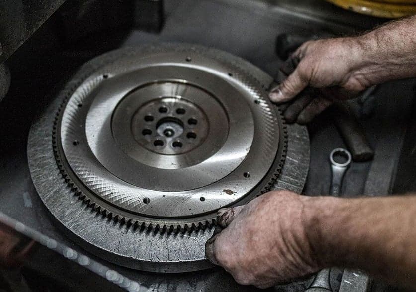 A mechanic working on a brake flywheel