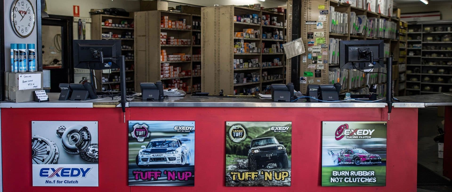 An automotive parts counter with stocked shelves behind it
